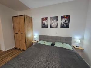 a bedroom with a large bed and two night stands at Herzstück in Ansbach