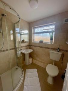 a bathroom with a toilet a sink and a shower at Look no further Gorgeous newly renovated contemporary chalet Sandown Bay Holiday Centre in Sandown