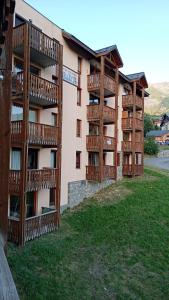 a building with wooden balconies on the side of it at Apartment for 5-7 people in Saint-François-Longchamp