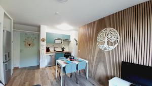 a living room with a table and a kitchen at Apartment for 5-7 people in Saint-François-Longchamp