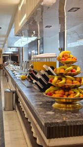 a kitchen with a counter with plates of fruit on it at فندق مثابة مكة in Makkah