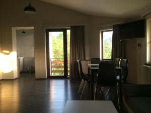 a living room with a table and chairs and a couch at Family room in Bakuriani in Bakuriani