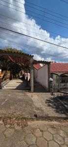 an old building with a red roof and a garage at Casa Chique in São Lourenço