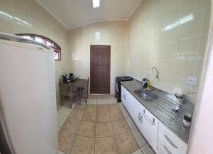 a kitchen with a sink and a table in it at Casa Chique in São Lourenço