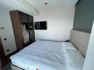 a small bedroom with a white bed and a closet at Marriot by Batumi in Batumi +10 photos