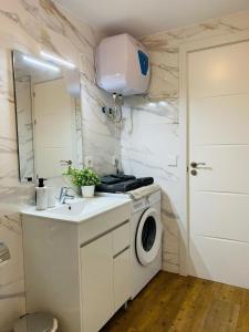 a bathroom with a washing machine and a sink at BEACH Arguineguin SEA VIEW 6 CHG FAMILY HOTEL in Arguineguín +40 photos