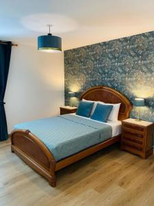 a bedroom with a large bed with blue pillows at BEACH Arguineguin SEA VIEW 6 CHG FAMILY HOTEL in Arguineguín