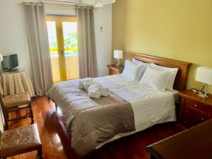 a bedroom with a large bed with towels on it at Apartamento da Torre in Mondim de Basto