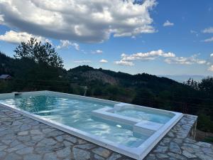 a swimming pool with a view of a mountain at Hotel Belica in Struga