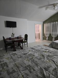 a bedroom with a dining room table and a bed at Midtown Guest House in Mobile
