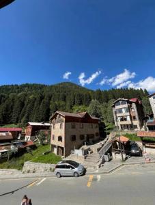 a car parked in a parking lot next to a building at BAHAR APART in Ayder Yaylasi