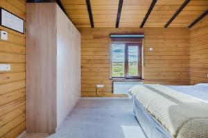 a bedroom with wooden walls and a bed in a room at Large luxury Cabin On The Golden Circle Next To Kerið The Crater. in Selfoss +43 photos