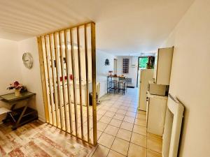 a hallway with a door to a kitchen with a table at Le cosy - T2 52m2 - Proche Gare TGV et RCEA in Le Breuil