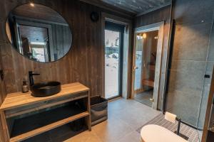 a bathroom with a sink and a mirror at Luxury holiday home, skiing, sauna, remote office in Nystølen +65 photos