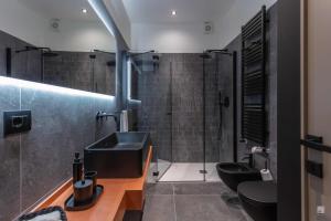 a bathroom with a sink and two toilets at Luxury House In Bologna Marchesana 150 mq in Bologna