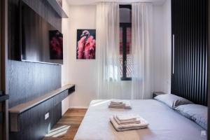 a bedroom with a bed with two towels on it at Luxury House In Bologna Marchesana 150 mq in Bologna
