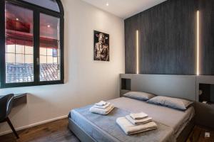 a bedroom with a bed with towels on it at Luxury House In Bologna Marchesana 150 mq in Bologna