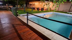 a large swimming pool with a fence around it at Windmill Hostel in Mendoza