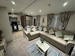 a living room with a couch and a table at Pebble Breeze in Ingoldmells