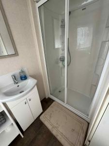 a bathroom with a shower and a sink at Pebble Breeze in Ingoldmells +10 photos