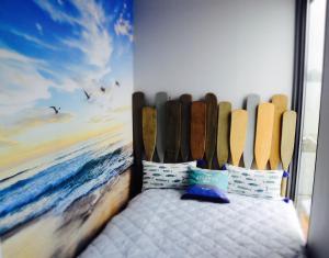 a bedroom with a surfboard mural on the wall at Hausboot Hafenprinz Lübeck in Brodten