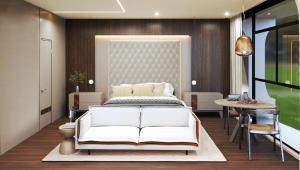 a bedroom with a white bed and a table at Tivoli Maiorana Belém Pará Hotel in Belém