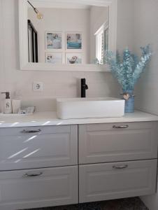 a white bathroom with a sink and a mirror at Warm Harbor in Santa Coloma de Gramanet +53 photos