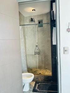 a bathroom with a shower with a toilet at Casa con vista al lago y parqueo en la zona viva in San Pedro La Laguna +39 photos