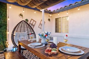 a wooden table with plates of food and wine at 4BR Desert Escape PoolGame Room in Bermuda Dunes