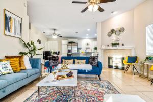 a living room with blue couches and a fireplace at 4BR Desert Escape PoolGame Room in Bermuda Dunes