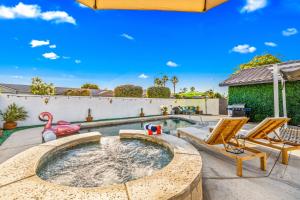 a backyard pool with a hot tub with a flamingo at 4BR Desert Escape PoolGame Room in Bermuda Dunes