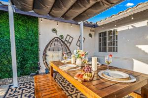 a wooden table with plates of food on a patio at 4BR Desert Escape PoolGame Room in Bermuda Dunes