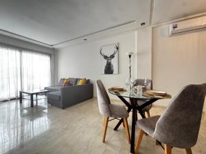 a living room with a table and a couch at Cozy green studio - Self check in, Prime location, Free parking in Casablanca