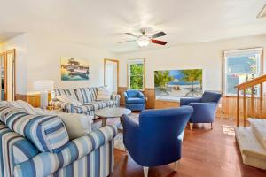 a living room with couches and chairs and a ceiling fan at 7074 - Seashells and Sunsets in Nags Head