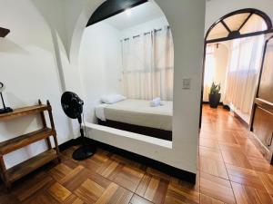 a bedroom with a bed in a room with a window at Casa con vista al lago y parqueo en la zona viva in San Pedro La Laguna