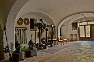 a room with a bunch of utensils on the wall at Masseria Vagone in Macchia di Monte