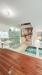 a swimming pool in a room with a table and a desk at View Theras Hotel in Doradal