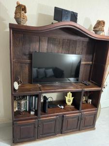 a large entertainment center with a flat screen tv at Casa Condo Diamante, Nueva Vallarta in Nuevo Vallarta