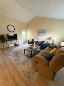 a living room with a couch and a table at The Corner Cottage in Palm Harbor