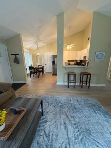 a living room with a couch and a table at The Corner Cottage in Palm Harbor