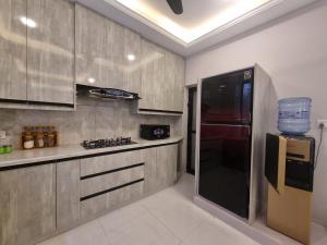 a kitchen with a black and red refrigerator at Fantastic Spanish Villas In Heart Of Mirpur Azad Kashmir Pakistan in Rachiāl