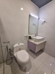 a white bathroom with a toilet and a sink at Fantastic Spanish Villas In Heart Of Mirpur Azad Kashmir Pakistan in Rachiāl