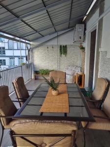 a table and chairs on a balcony with a table and a couch at Valtellina -La Casina Sondrio in Sondrio