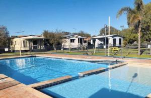 a large swimming pool in front of some houses at Family Getaway Cabin 50 in Broadwater
