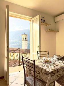 a dining room with a table and a view of a lighthouse at Sebino Holiday Home Monteisola in Monte Isola