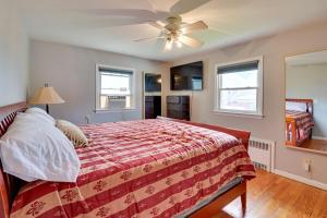 a bedroom with a bed and a ceiling fan at The Vault Your Fun Secured in Hillside