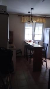 a kitchen with a table and chairs in a room at La solana in Soto del Real