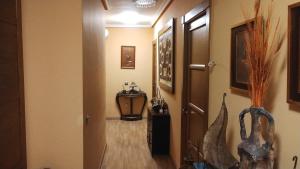 a hallway with a door and a table in a room at La solana in Soto Real