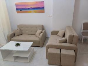 a living room with a couch and a table at Filocsenia sea side in Tsoutsouros