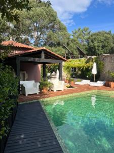 a backyard with a swimming pool and a pavilion at Enoturismo Novavila Rias Baixas Wine Design in Meis